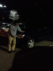 Sophomore Ben Hayes stands next to his car, which suffered a flat tire right before he planned to head home.