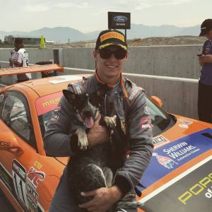 Thompson with his dog Cooper after another win in his Porsche. 